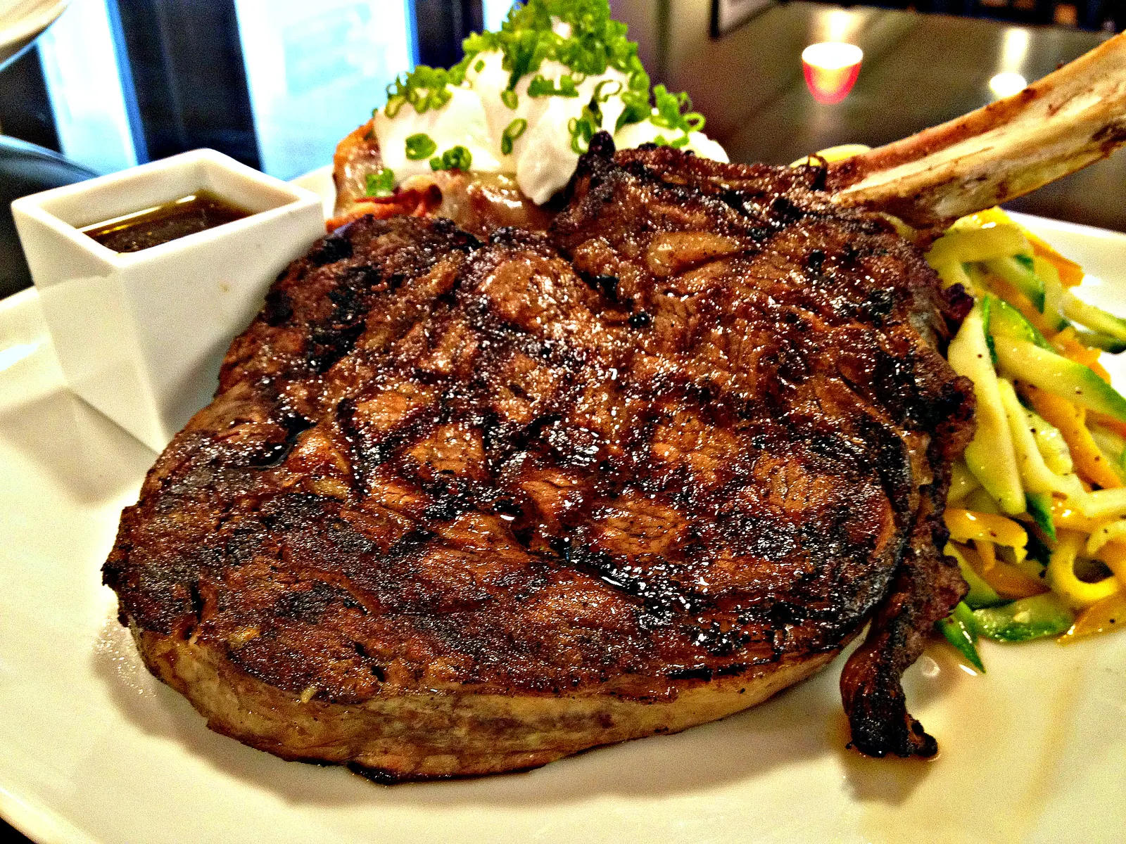 Fitzpatrick's grilled bone-in steak with vegetables and a baked potato